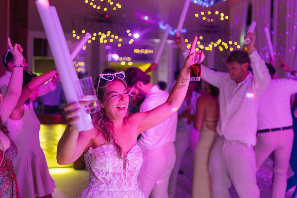 Bride with light sticks on the dance floor